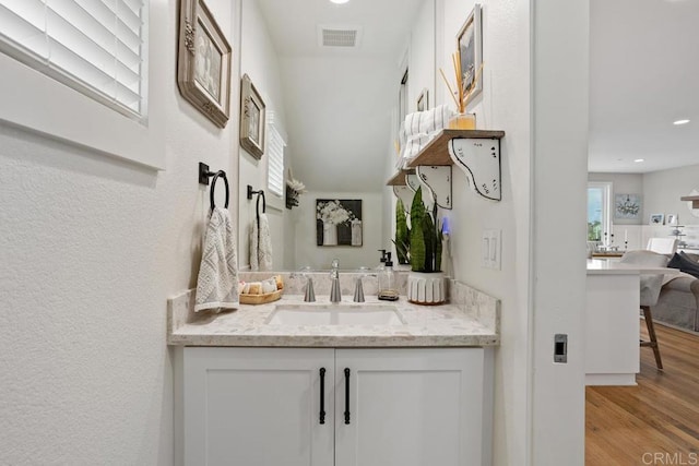 bathroom featuring visible vents, recessed lighting, vanity, and wood finished floors