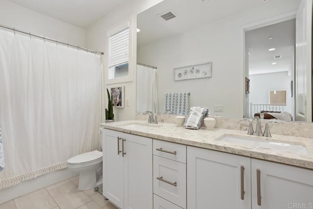ensuite bathroom with toilet, tile patterned floors, a sink, and visible vents