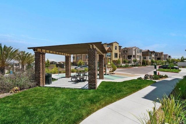 view of property's community featuring a pergola, a residential view, a patio area, and a lawn