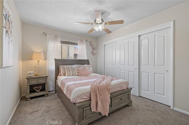 78675 Bradford Cir, La Quinta, CA 92253 - bedroom with a closet, baseboards, light colored carpet, and a textured ceiling