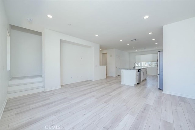 1245 Oliva Ct, Duarte, CA 91010 - unfurnished living room with recessed lighting and light wood-style floors