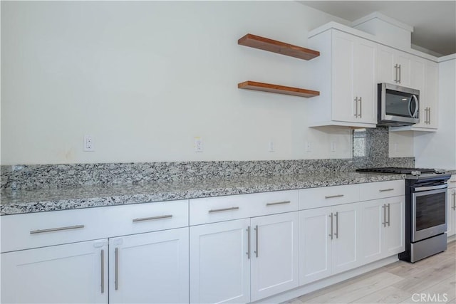 1245 Oliva Ct, Duarte, CA 91010 - kitchen featuring stainless steel appliances, open shelves, light wood-type flooring, light stone counters, and white cabinets