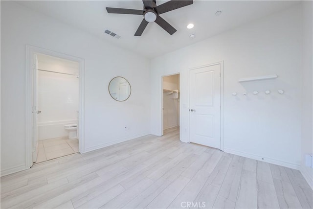 1245 Oliva Ct, Duarte, CA 91010 - unfurnished bedroom featuring light wood finished floors, a walk in closet, ensuite bath, and a ceiling fan