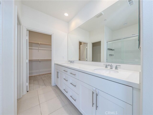1245 Oliva Ct, Duarte, CA 91010 - full bath with a shower stall, double vanity, a spacious closet, and tile patterned floors