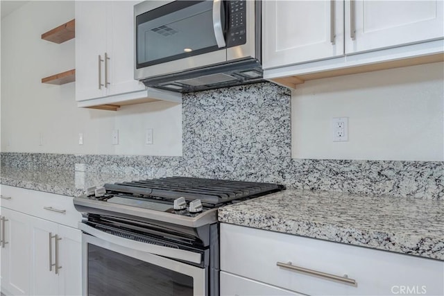1245 Oliva Ct, Duarte, CA 91010 - kitchen with appliances with stainless steel finishes, open shelves, decorative backsplash, white cabinetry, and light stone countertops