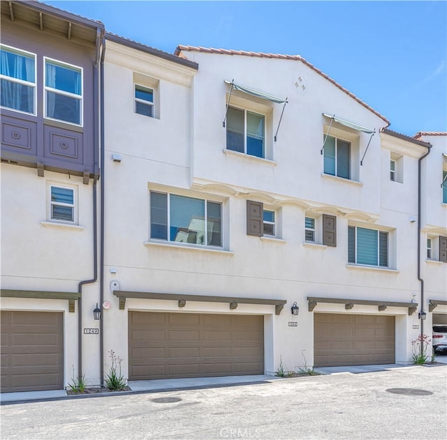 1245 Oliva Ct, Duarte, CA 91010 - rear view of house with stucco siding and an attached garage