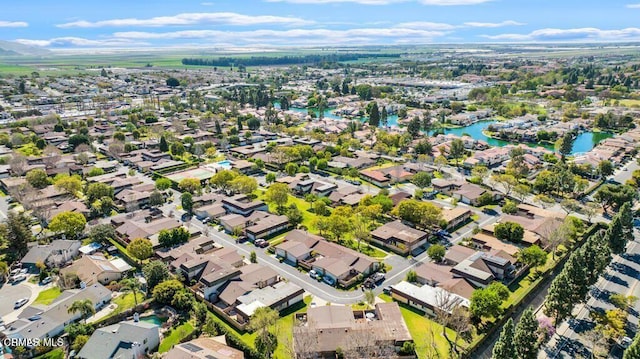 birds eye view of property featuring a water view and a residential view