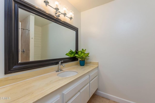 bathroom featuring vanity, baseboards, and tile patterned floors