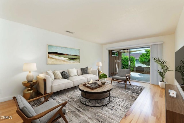 living area with visible vents and wood finished floors
