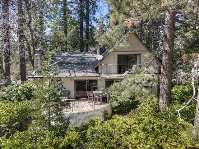 28018 Peninsula, Lake Arrowhead, CA 92352 - view of front of home with a balcony, a chimney, and roof with shingles