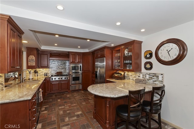 28018 Peninsula, Lake Arrowhead, CA 92352 - kitchen featuring stainless steel appliances, a peninsula, a warming drawer, brick floors, and light stone counters