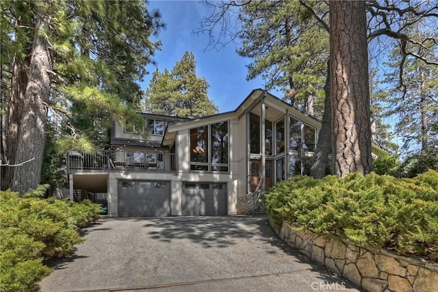 28018 Peninsula, Lake Arrowhead, CA 92352 - view of front facade with driveway, a garage, and a balcony