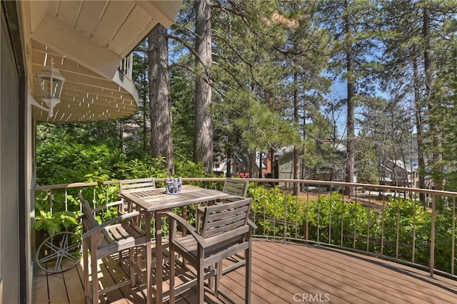 28018 Peninsula, Lake Arrowhead, CA 92352 - deck featuring outdoor dining area and view of wooded area
