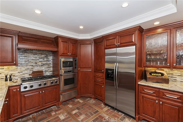 28018 Peninsula, Lake Arrowhead, CA 92352 - kitchen featuring built in appliances, a warming drawer, brick patterned flooring, crown molding, and decorative backsplash
