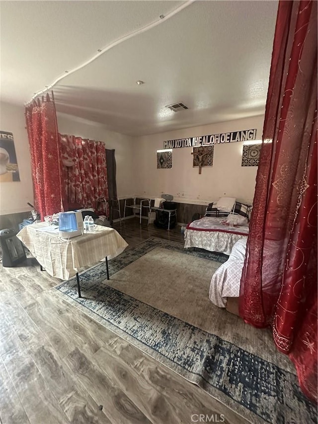 bedroom with wood finished floors and visible vents