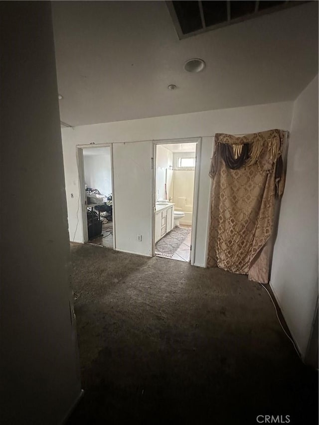 interior space with ensuite bath and carpet