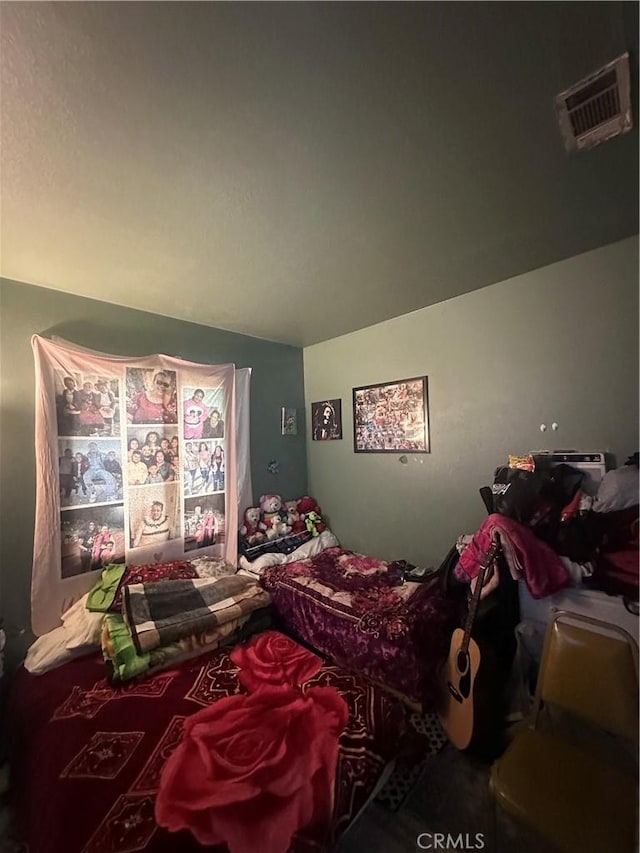 bedroom with visible vents and vaulted ceiling