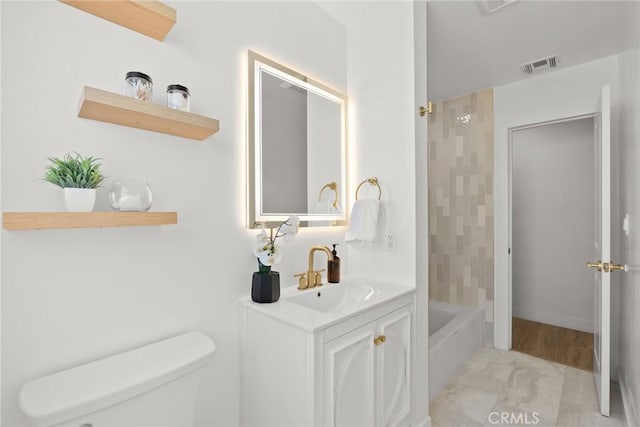 bathroom with vanity, toilet, shower / tub combination, and visible vents