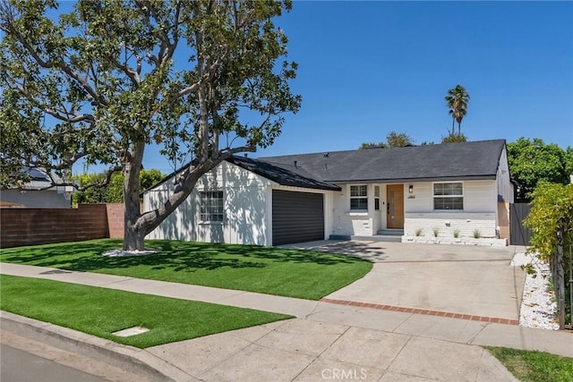 ranch-style house with fence, an attached garage, driveway, and a front yard