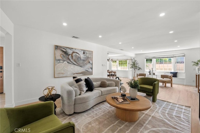 13807 Wyandotte St, Van Nuys, CA 91405 - living room featuring recessed lighting, wood finished floors, baseboards, and arched walkways
