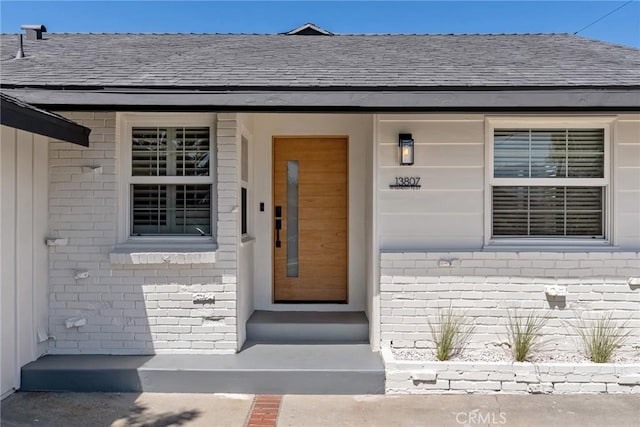 13807 Wyandotte St, Van Nuys, CA 91405 - property entrance with brick siding and a shingled roof