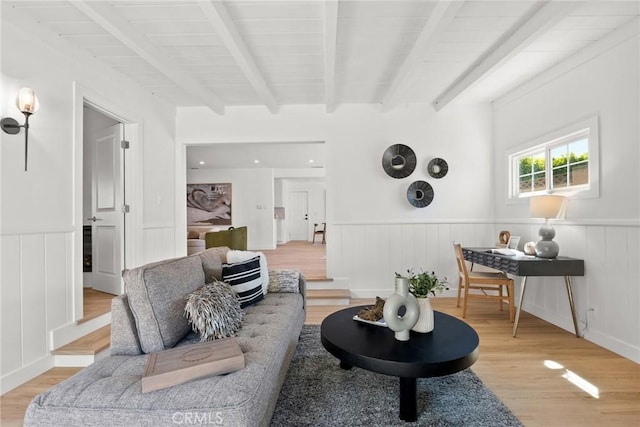 13807 Wyandotte St, Van Nuys, CA 91405 - living room with light wood finished floors, beam ceiling, a wainscoted wall, and a decorative wall