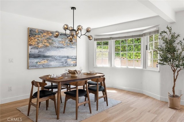 13807 Wyandotte St, Van Nuys, CA 91405 - dining area with light wood-style floors, plenty of natural light, baseboards, and beam ceiling