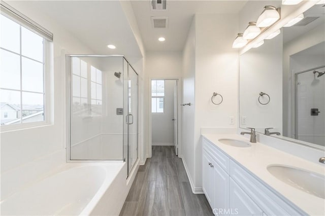 full bath featuring a sink, visible vents, a stall shower, and a garden tub