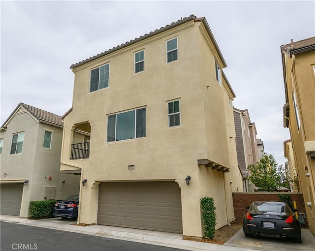 view of front of property with an attached garage and stucco siding