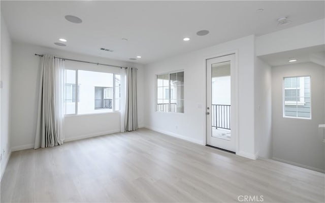 spare room with visible vents, baseboards, light wood-type flooring, and recessed lighting