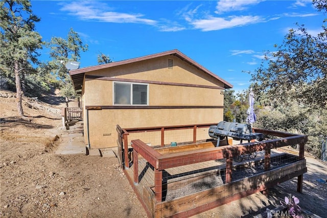 1897 Desert Front Rd, Wrightwood, CA 92397 - view of side of home with stucco siding