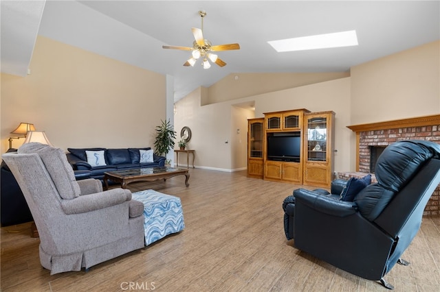1400 Genoa Way, Santa Maria, CA 93455 - living area with baseboards, a ceiling fan, light wood-style floors, a fireplace, and lofted ceiling with skylight