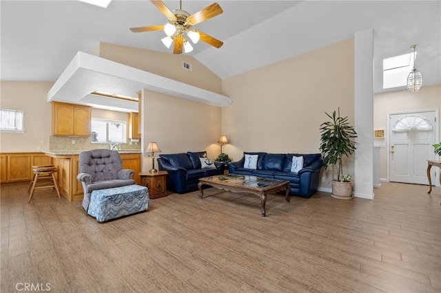 1400 Genoa Way, Santa Maria, CA 93455 - living area with vaulted ceiling with skylight, a ceiling fan, visible vents, and light wood-type flooring