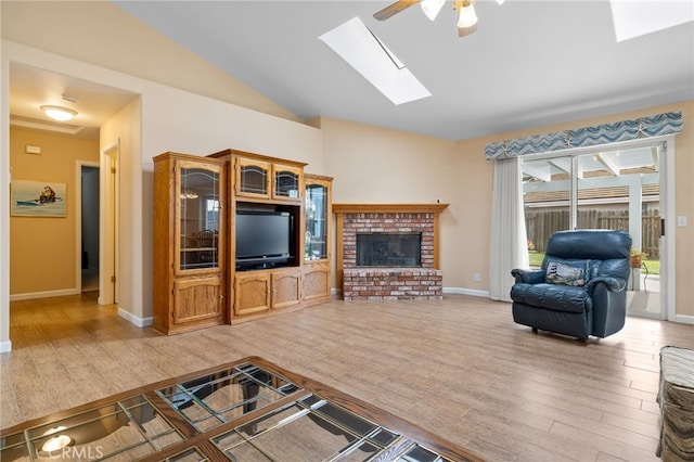 1400 Genoa Way, Santa Maria, CA 93455 - living area featuring light wood-style flooring, vaulted ceiling with skylight, ceiling fan, and a fireplace