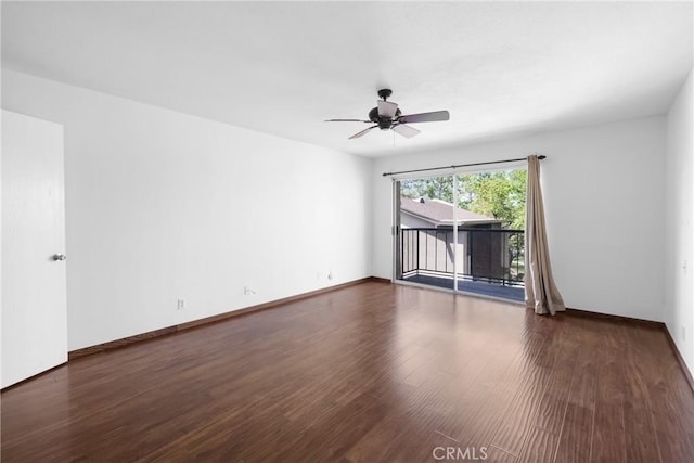 spare room with wood finished floors, baseboards, and a ceiling fan