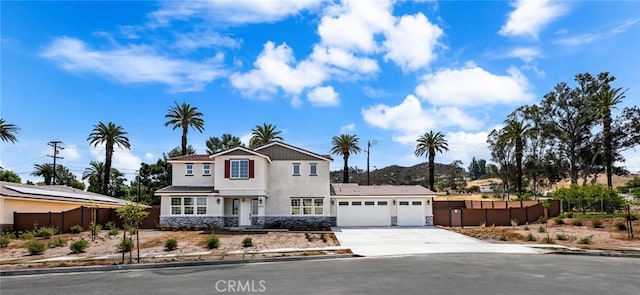 5978 Copperfield Ave, Riverside, CA 92506 - traditional-style house with an attached garage, concrete driveway, stucco siding, and a mountain view