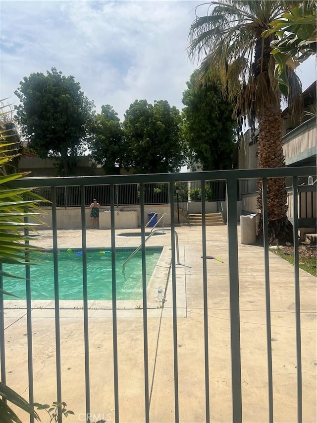 view of swimming pool with fence and a fenced in pool
