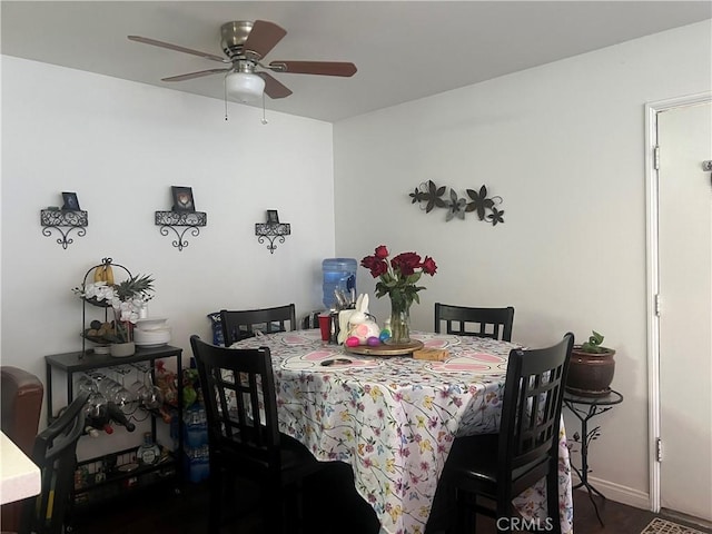 dining room with ceiling fan and baseboards