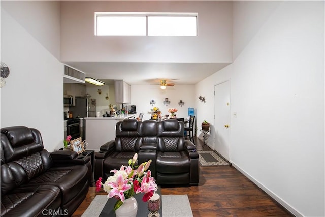 8601 International Ave Unit 265, Canoga Park, CA 91304 - living area with a high ceiling, dark wood-type flooring, healthy amount of natural light, a ceiling fan, and baseboards