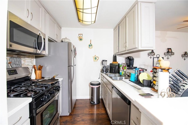 8601 International Ave Unit 265, Canoga Park, CA 91304 - kitchen with stainless steel appliances, tasteful backsplash, light countertops, a sink, and dark wood-type flooring