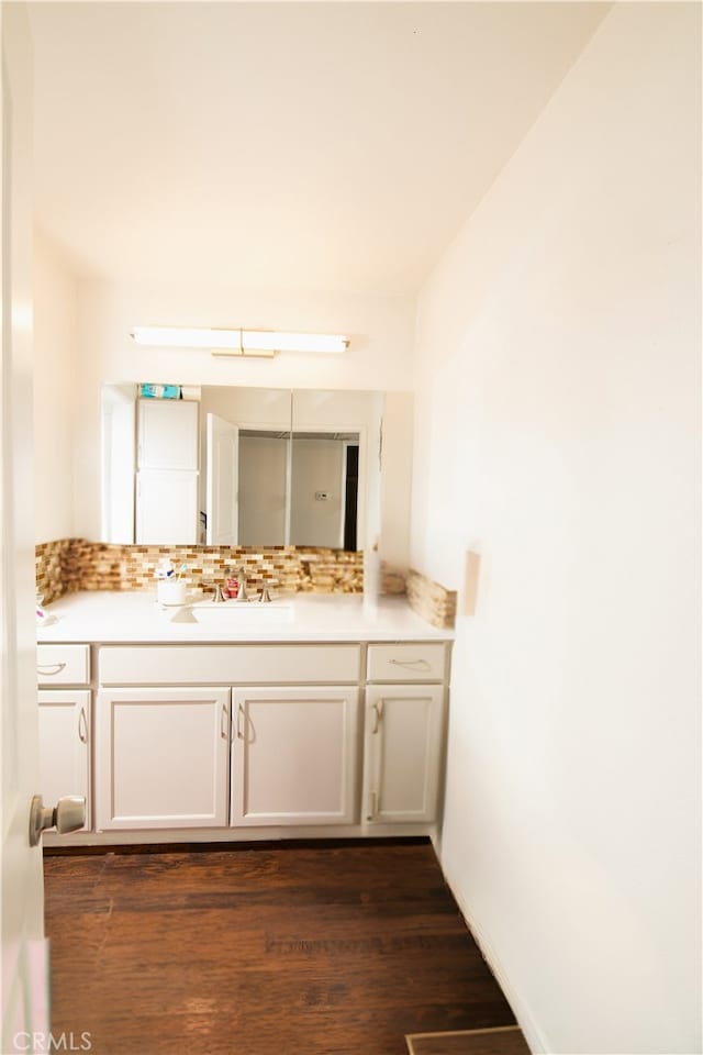 8601 International Ave Unit 265, Canoga Park, CA 91304 - bathroom with vanity, wood finished floors, and backsplash