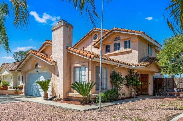 1104 Rachel Cir, Escondido, CA 92026 - mediterranean / spanish-style home with a garage, a tile roof, stucco siding, a chimney, and concrete driveway