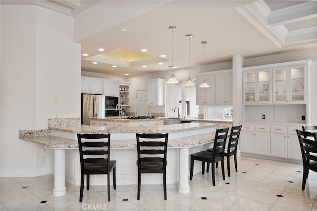 11 Sycamore Valley Rd, Chico, CA 95973 - kitchen featuring freestanding refrigerator, black microwave, a raised ceiling, a kitchen breakfast bar, and recessed lighting