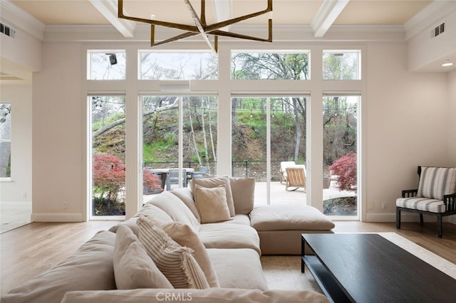 11 Sycamore Valley Rd, Chico, CA 95973 - living area with beam ceiling, crown molding, light wood-style flooring, baseboards, and a towering ceiling