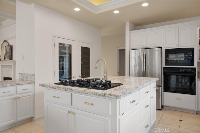 11 Sycamore Valley Rd, Chico, CA 95973 - kitchen featuring black appliances, light tile patterned floors, a center island with sink, recessed lighting, and light stone countertops