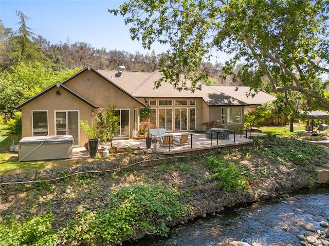 11 Sycamore Valley Rd, Chico, CA 95973 - rear view of property with a hot tub, a patio, and stucco siding