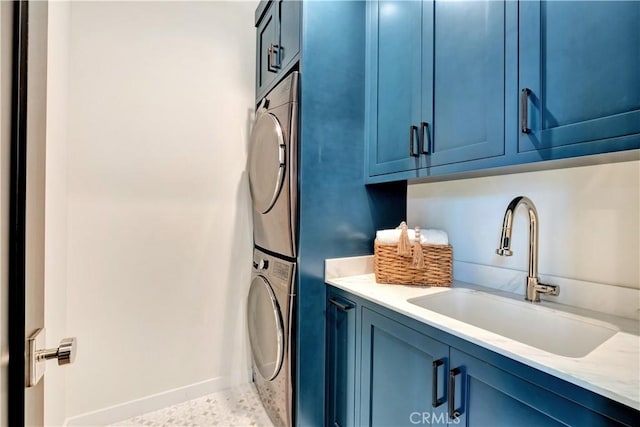 607 12th St, Huntington Beach, CA 92648 - laundry area with stacked washer / drying machine, cabinet space, and baseboards
