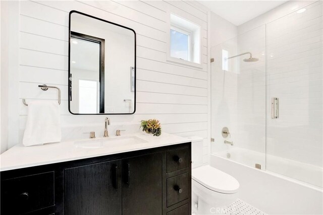 607 12th St, Huntington Beach, CA 92648 - full bath featuring toilet, vanity, wooden walls, and combined bath / shower with glass door