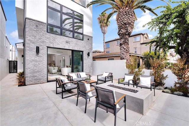 607 12th St, Huntington Beach, CA 92648 - view of patio featuring an outdoor living space with a fire pit and fence