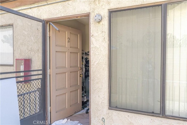 doorway to property with stucco siding
